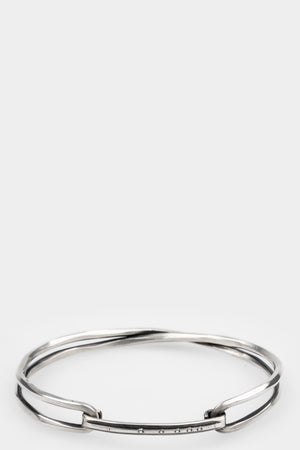 Werkstatt München | Crossed bangle bracelet M2211, shot on table