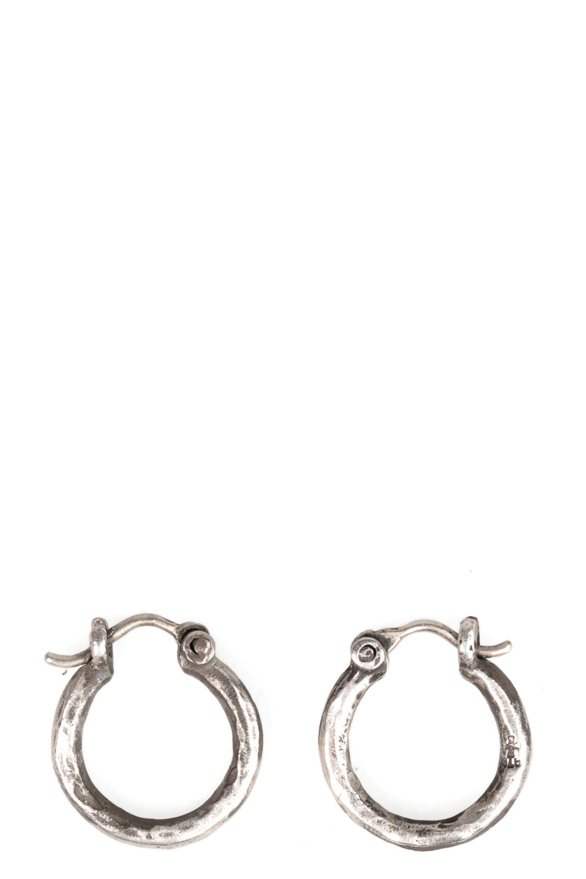 Certain Pace | Oval silver earrings, shot on table