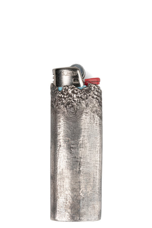 CUMA | Textured silver lighter case, shot on table