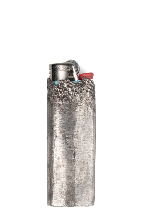 CUMA | Textured silver lighter case, shot on table