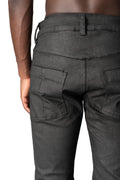 Coated stretch denim trousers