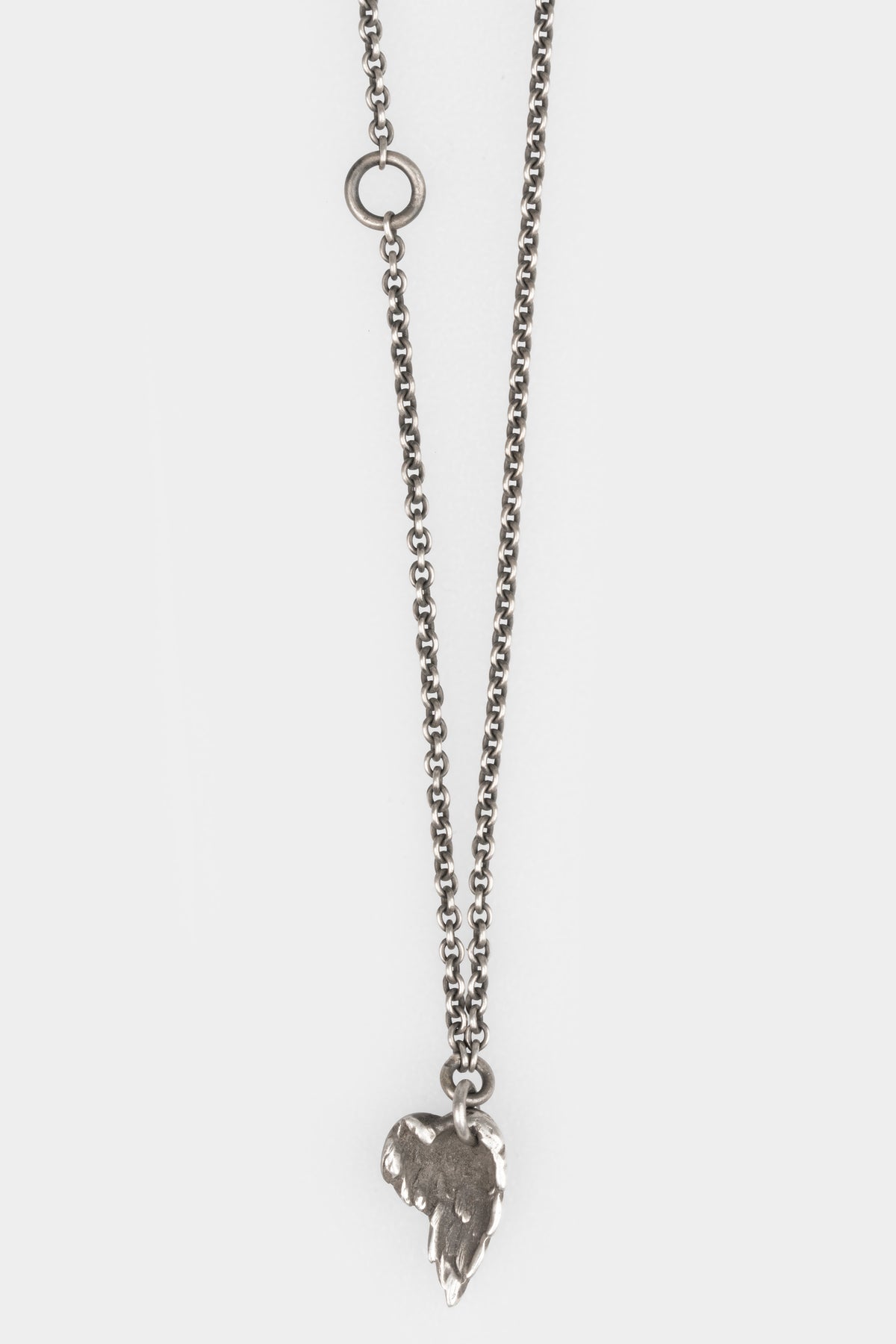 Werkstatt München | Mini eagle wing pendant necklace M7430, shot on table